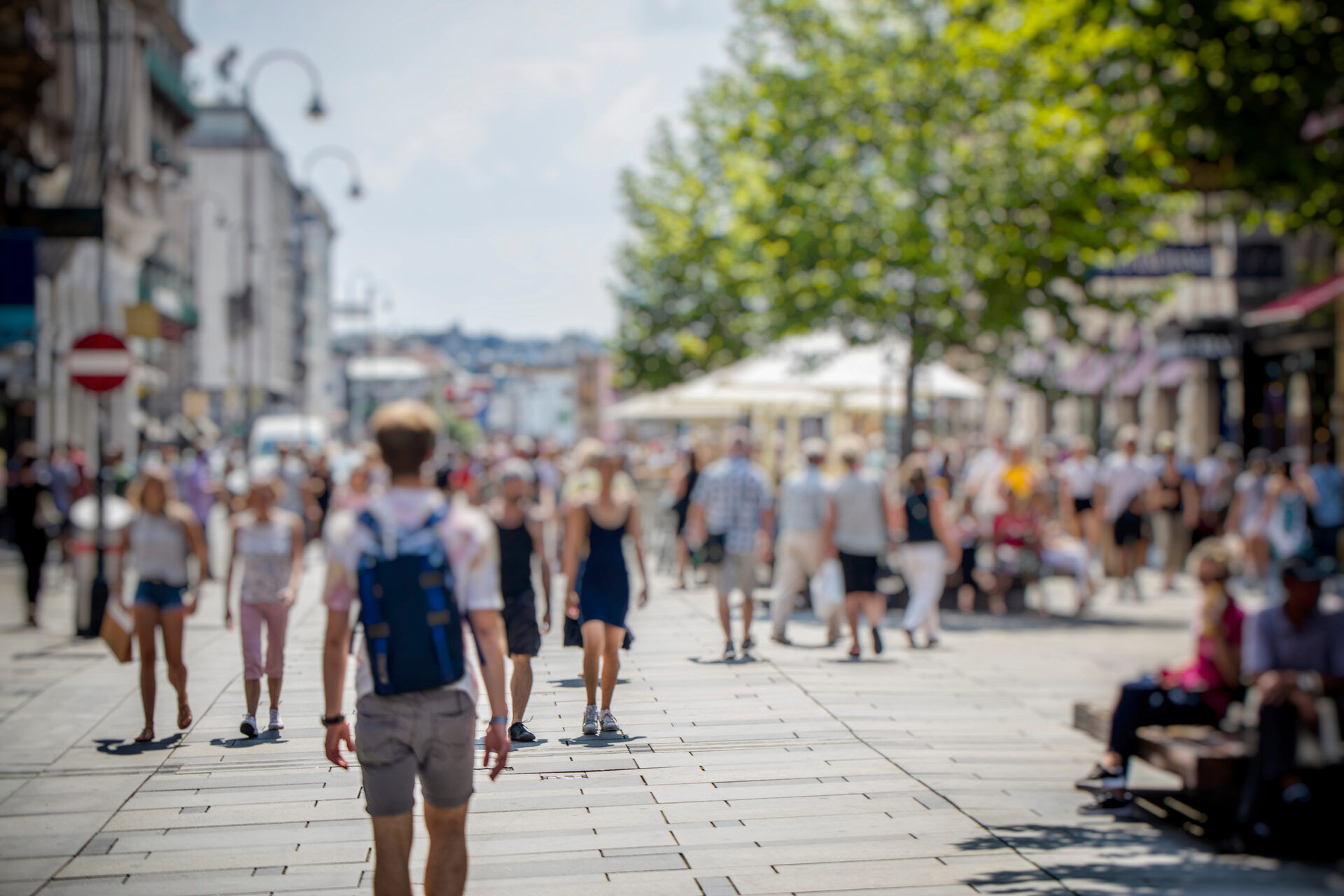 Busy city pedestrian street in summer